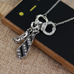 Handcuff Charm Necklace for Women – Silver Tone Chain with Mask & Tie Pendant – Edgy Statement Jewelry Gift (18”)